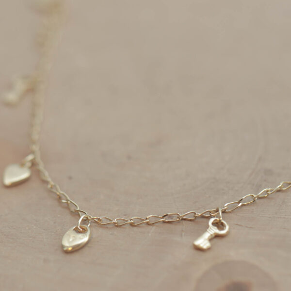 Børne armlænke med charms i 18 karat guld